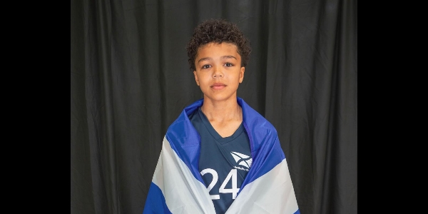 Ethan with the Scotland flag around his shoulders