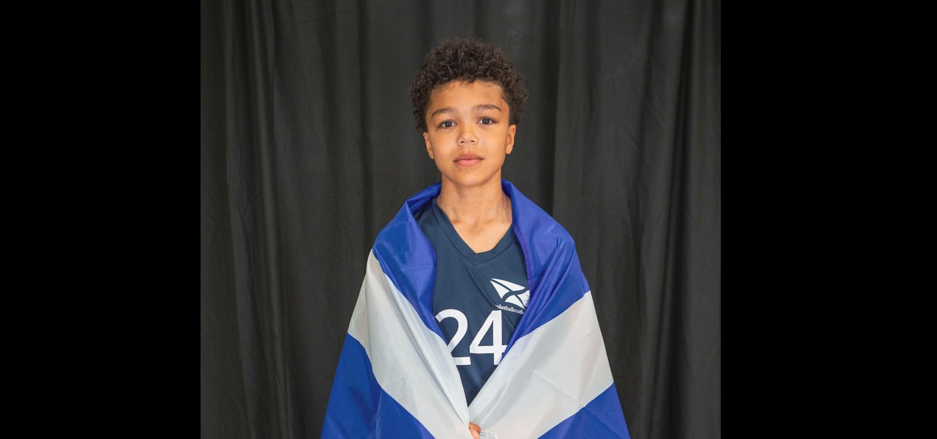 Ethan with the Scotland flag around his shoulders