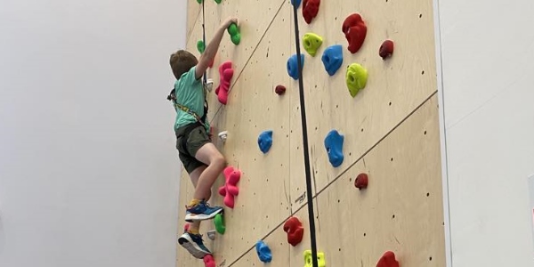 A child enjoying the climbing wall at Deveron Community and Sports Centre