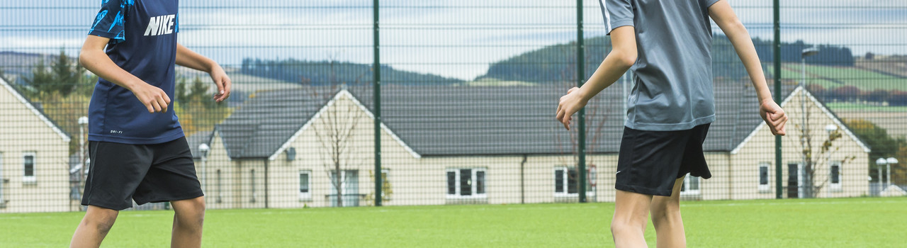 A couple of boys playing football