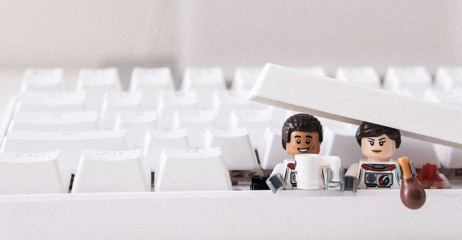 Lego figures emerging from keyboard