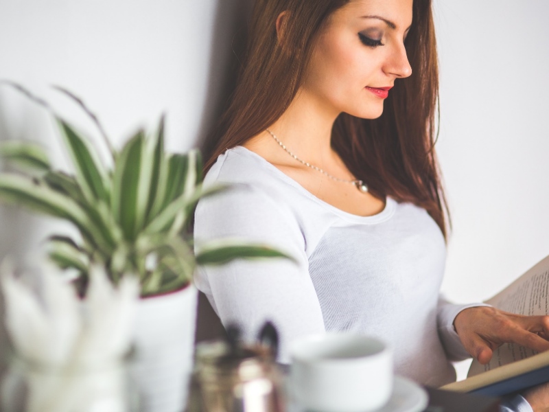 A woman reading a book at home