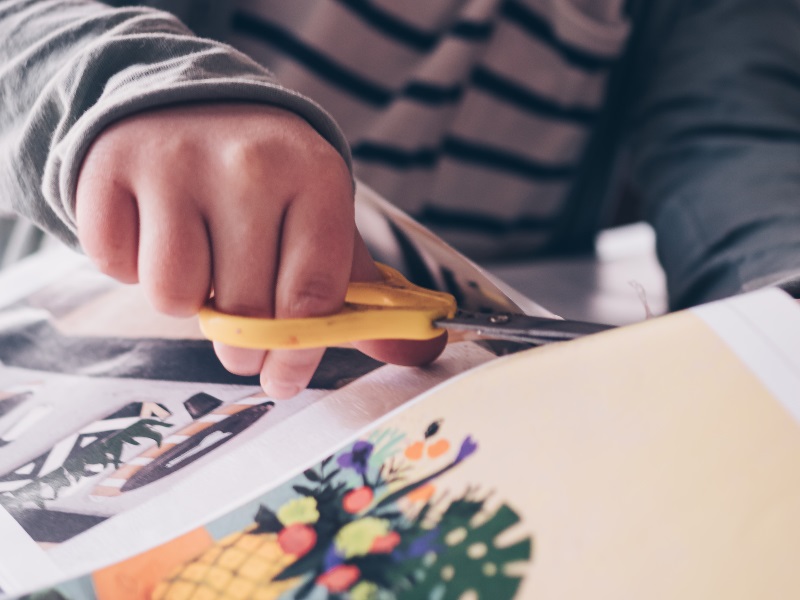 a person cutting out some paper