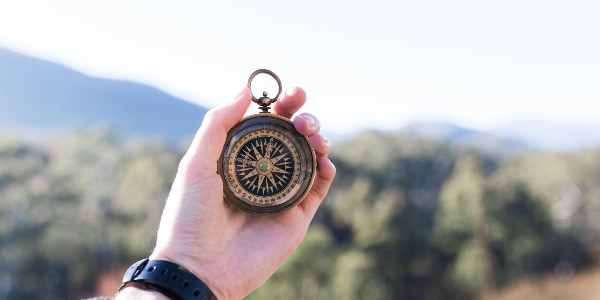 hand holding a compass