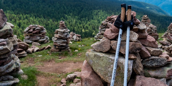 A small cairn with walking poles leaning against it