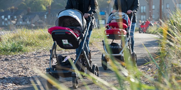 Two people pushing prams while enjoying a walk around Stonehaven