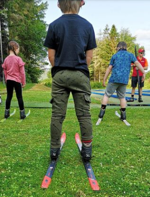 A group of children practising their skiing