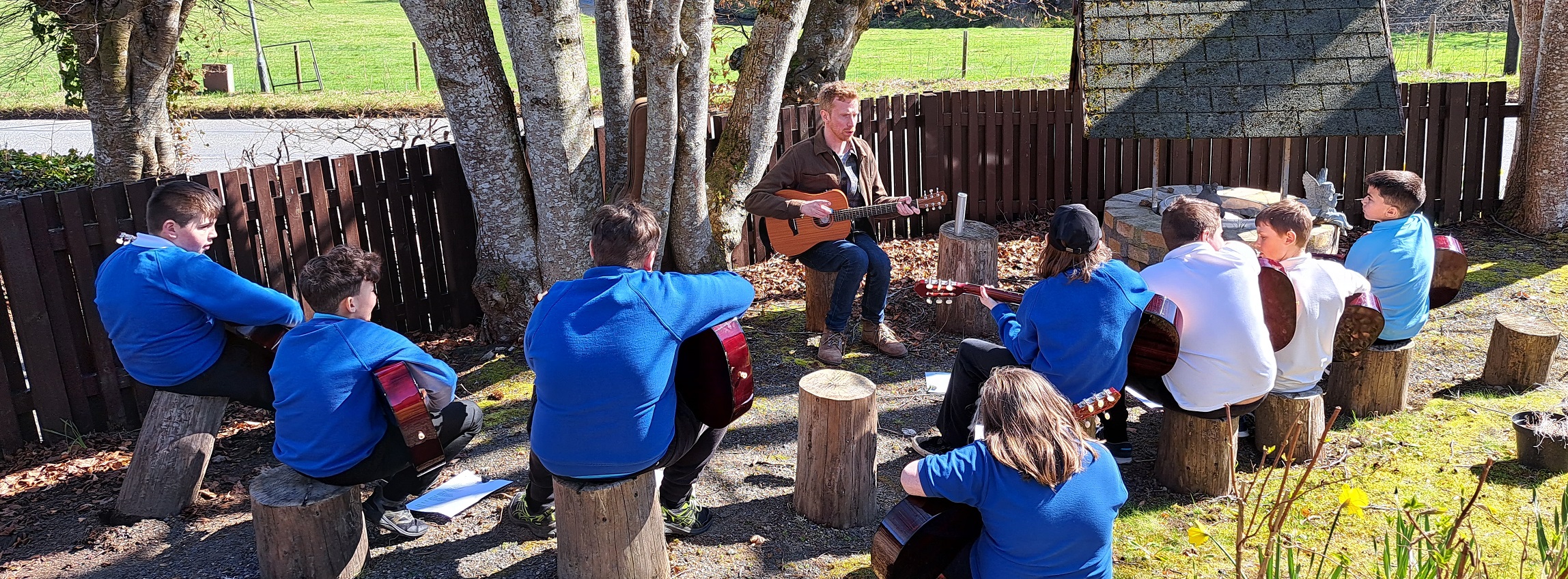 children playing guitars outside