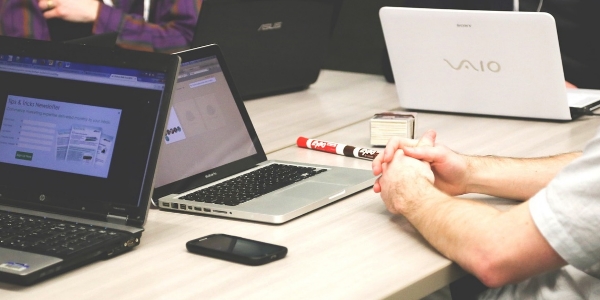 Someone working at a desk on a laptop