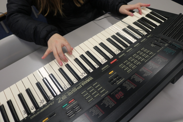 close up young person playing keyboard